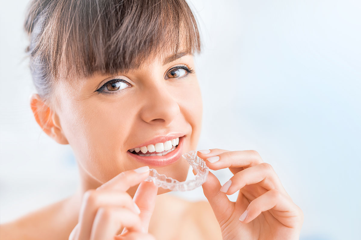 Woman with Invisalign aligner